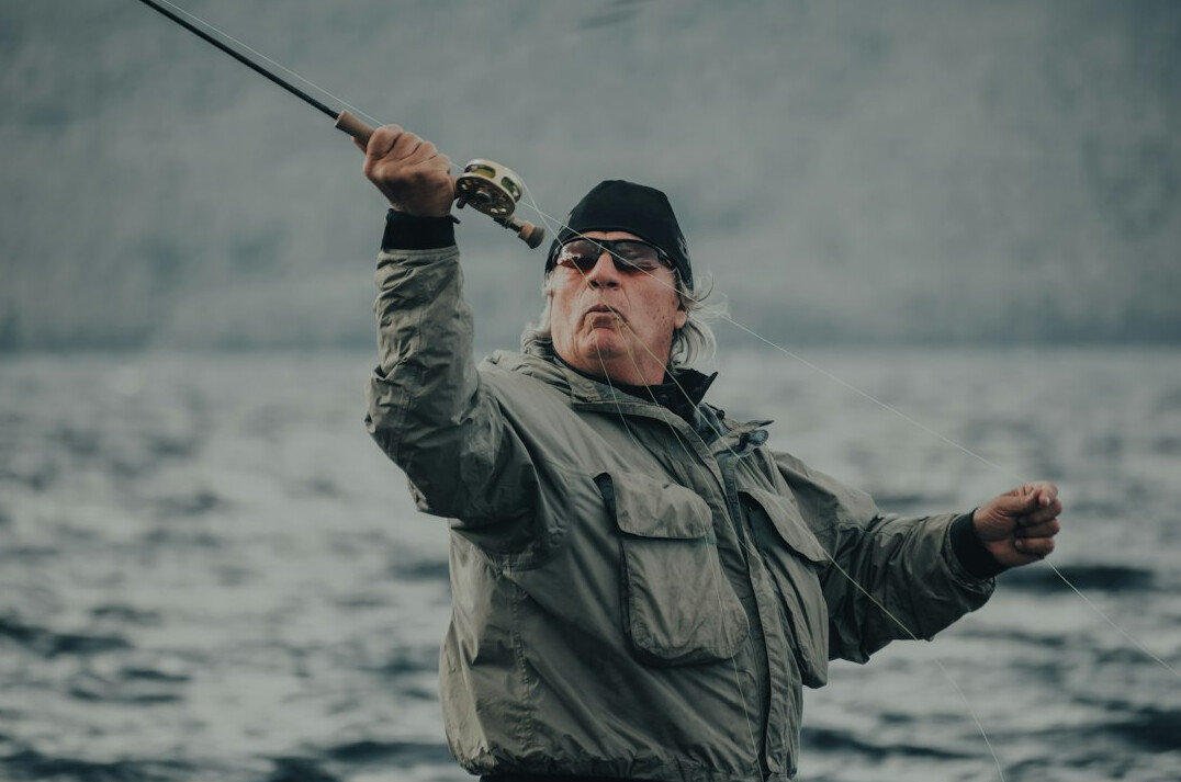 Portrait of an elderly Danish fisherman standing on a harbor pier