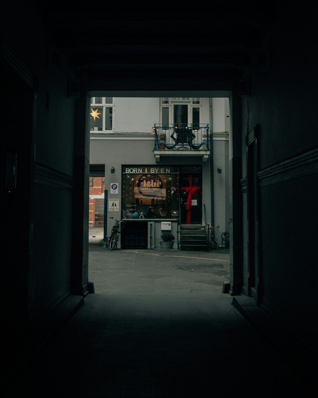 Portrait of a Danish baker standing in the doorway of a small bakery