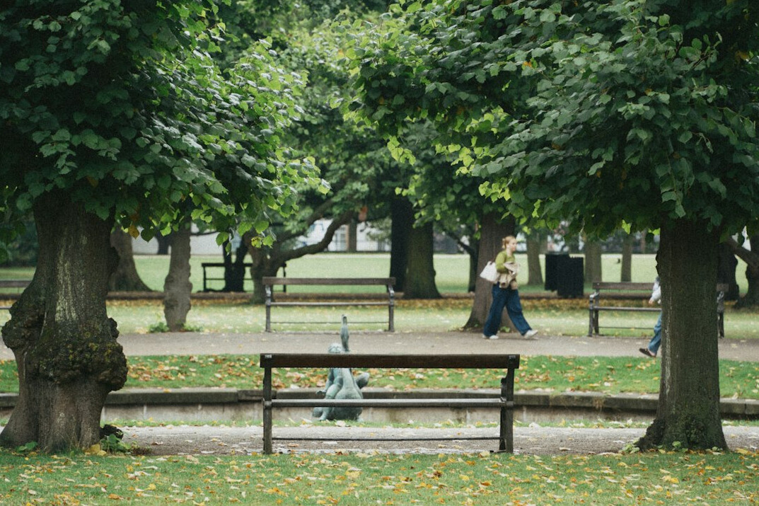 Elderly Danish man sitting alone on a park bench