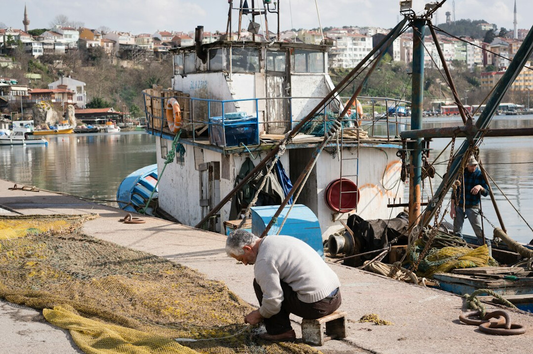 fisherman preparing boat at harbor
