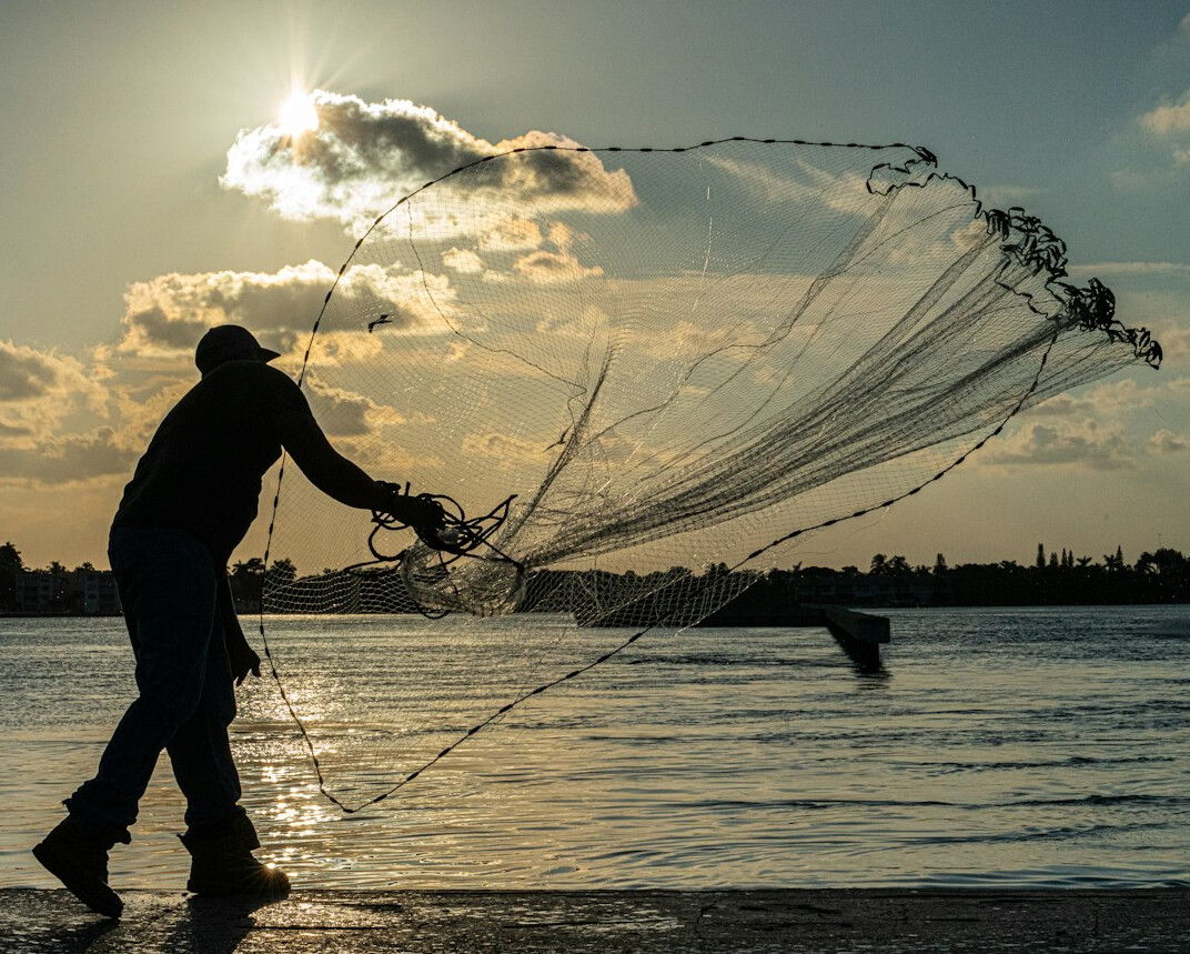 fisherman pulling fishing net