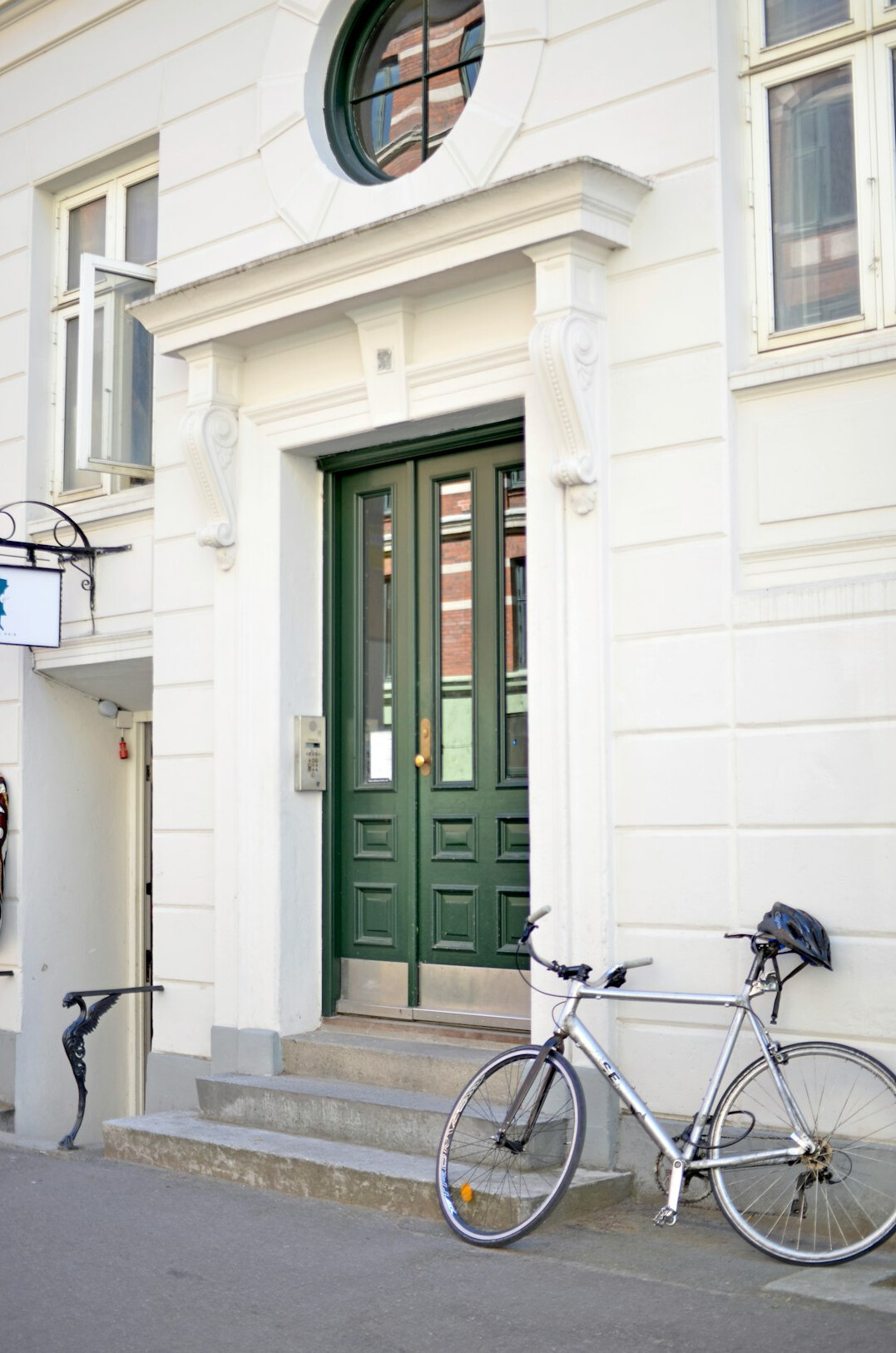 Bicycles parked along a quiet cobblestone street in a Danish town
